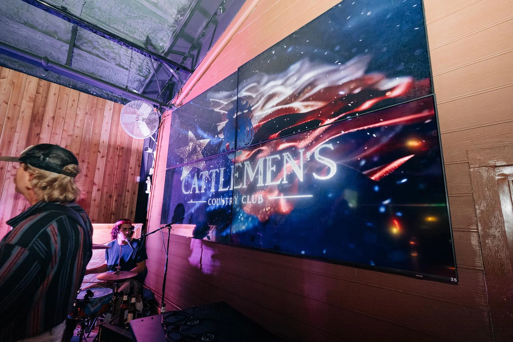 The stage LED screen at Cattlemen's Country Club carrying the venue's branding